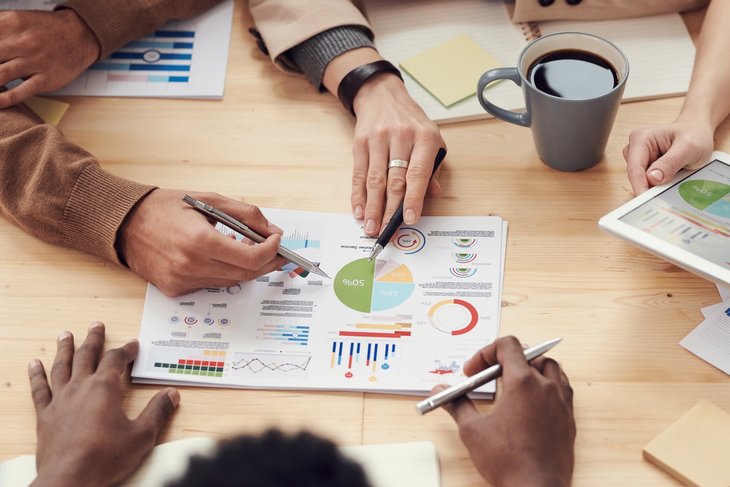 Group of people discussing charts and statistics