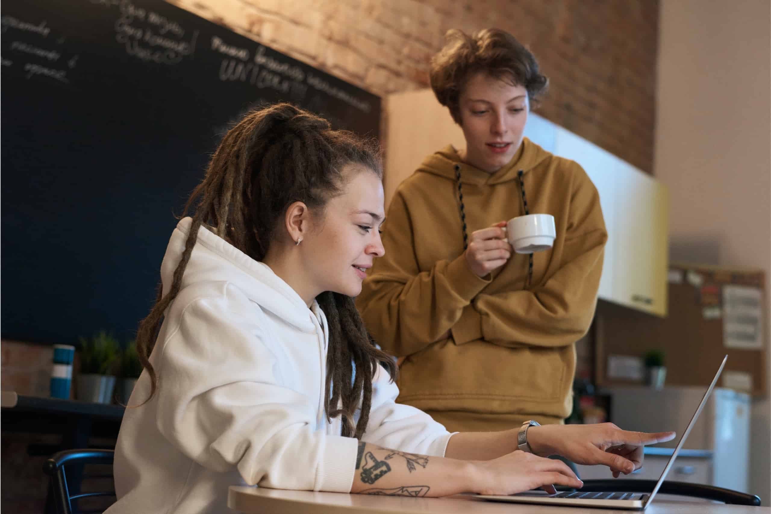 Two woman looking at a laptop screen together