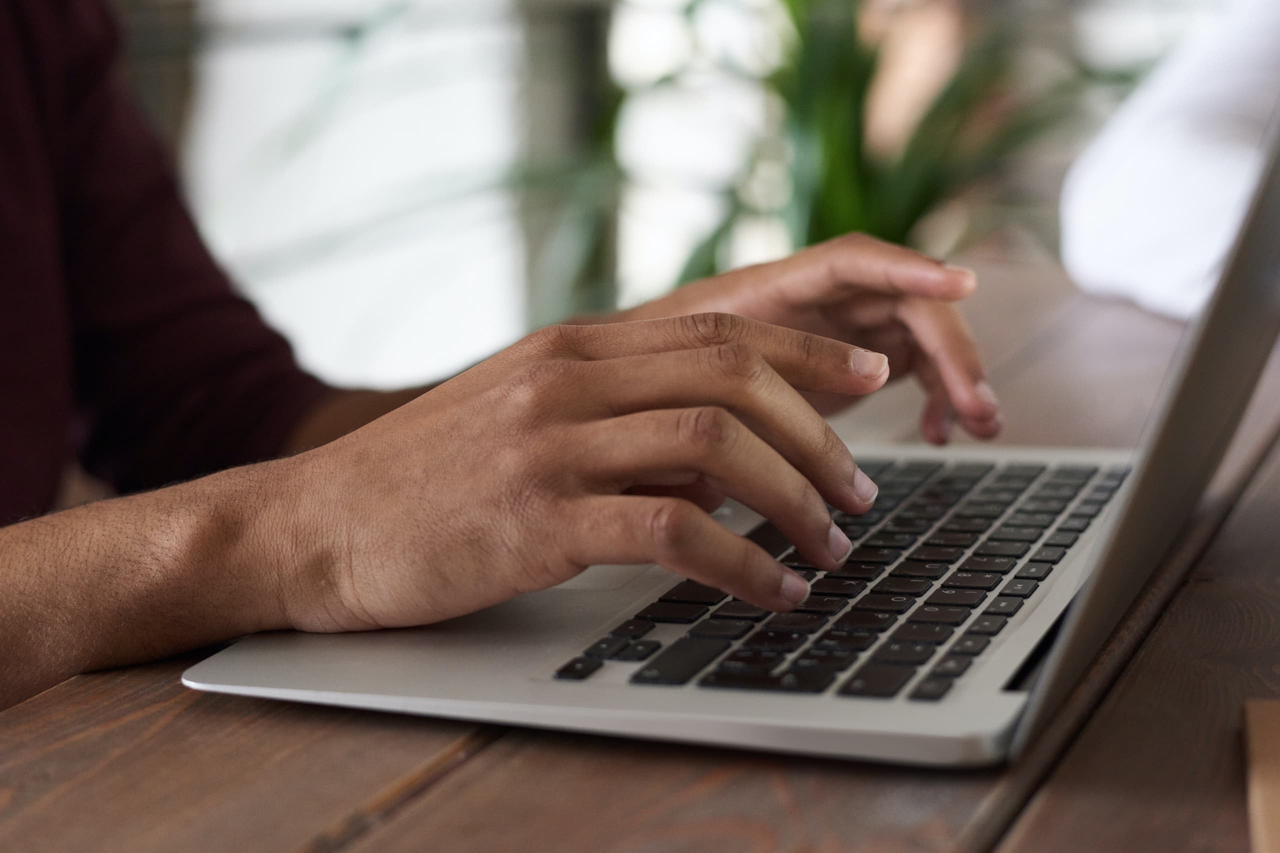 Person typing on a laptop keyboard