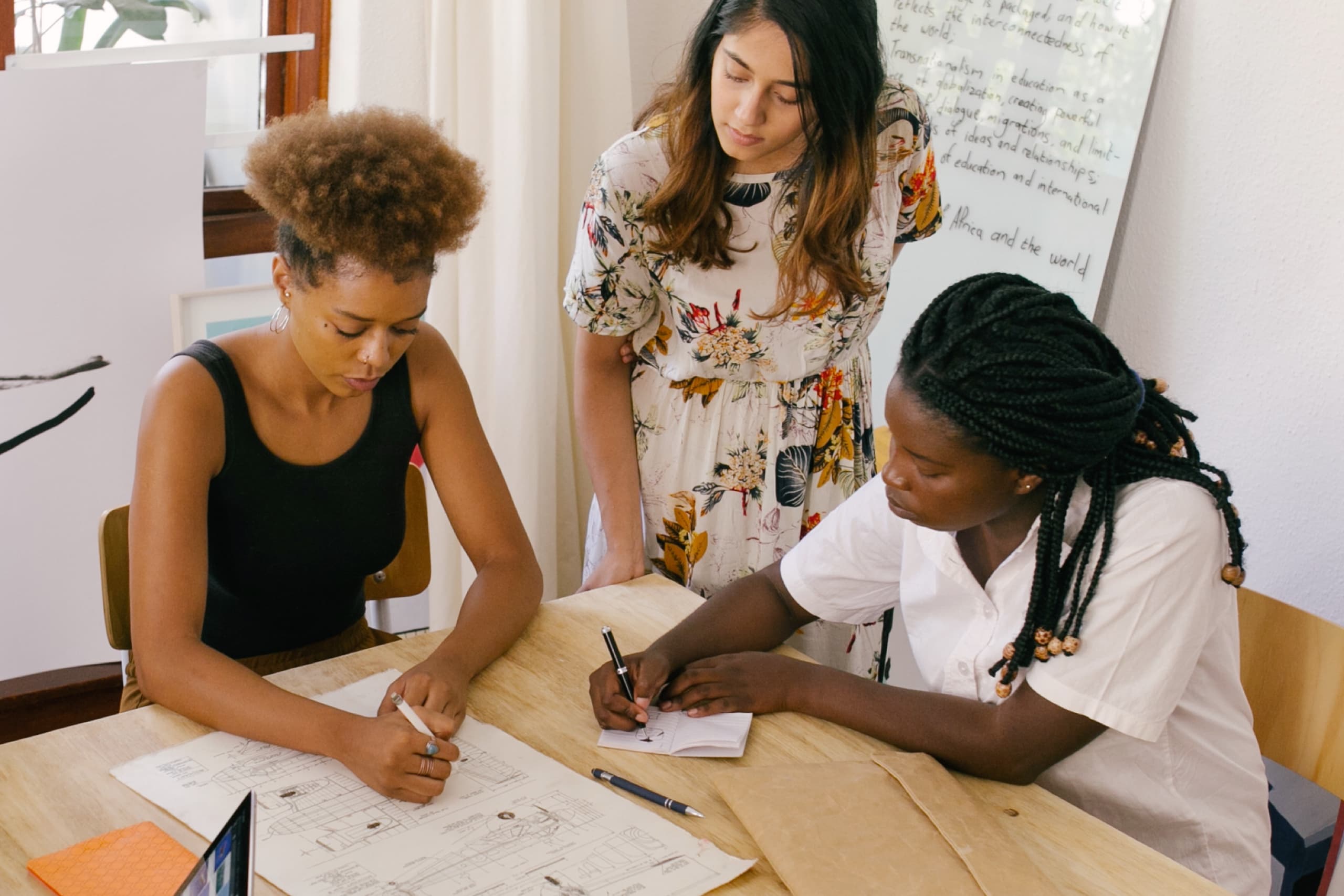 Team working together and writing on paper